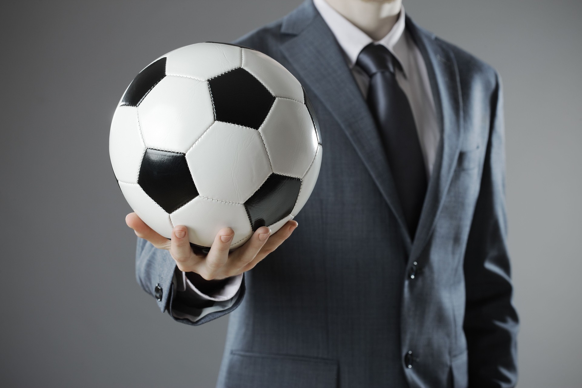Elegant businessman holding a soccer ball